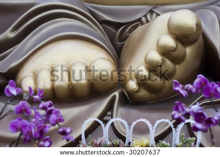 A close-up of Buddha\'s feet.  this Buddha is the laughing buddha, a buddha that\'s popular in Taiwan and China.