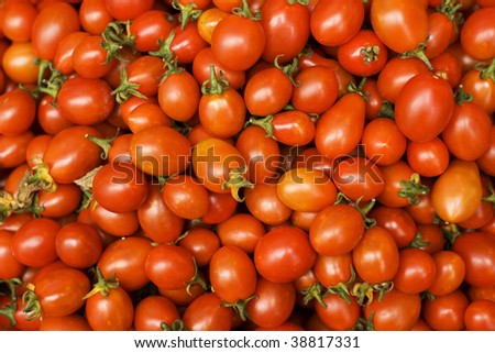 Fresh Tomatoes, the healthy choice.  These cherry tomatoes are on display in a market.  Tomatoes are a healthy and natural food.