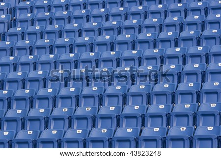 Blue seats in a stadium. These seats are numbered and make an ideal background.
