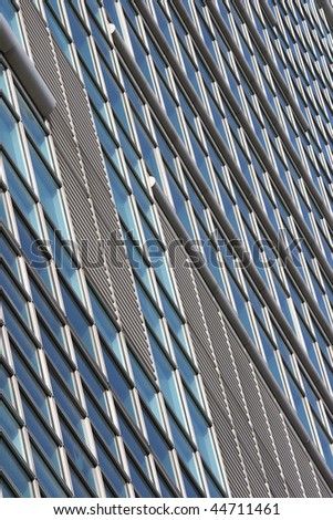 Exterior of a modern office building/skyscraper. This could be used as a background for business related items.