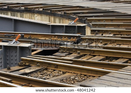 Close-up of a rail tracks on a rail turntable.  Turntables are used to help trains change tracks.
