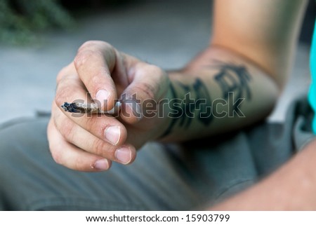 hand with tattoo and joy. addict