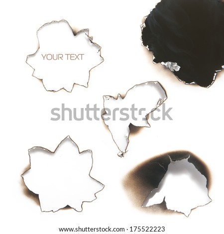 Collection of burnt holes in a piece of paper isolated on white