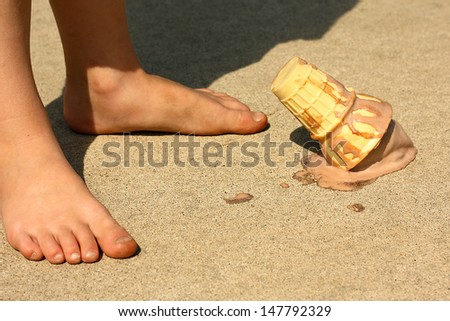 Child Drops Ice Cream Cone by Feet