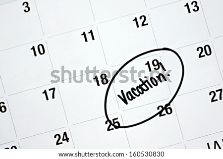 the word vacation is written in black marker and circled on a white monthly calendar