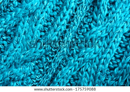 background of soft, cozy turquoise blue cable knit textured scarf or blanket fabric