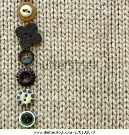 a row of natural colored vintage sewing buttons are lined up, framing tan tweed fabric square background
