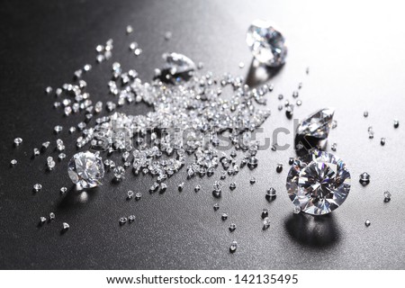 cut diamonds on shiny black surface