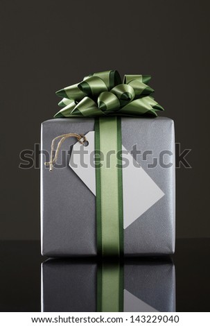 gray gift box black background.  gray Gift box with green ribbon.