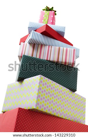 Wrapped presents stacked in the form of a pyramid with cute Gift box at the top. Group of presents. Gift boxes with origami bows.