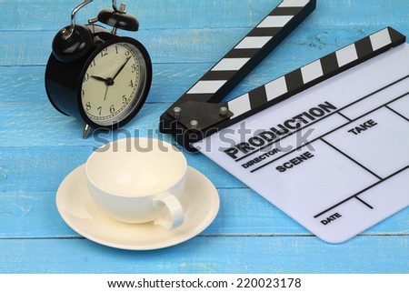 Blank movie clapper board with coffee cup and clock, slate film.
