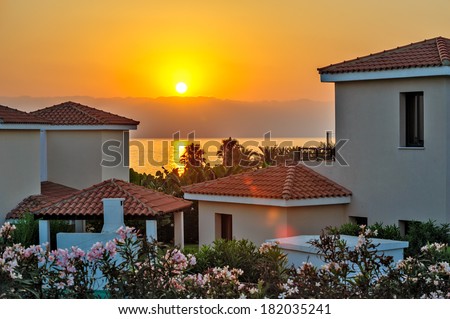 Sunset over luxurious holiday beach villas for rent on Cyprus