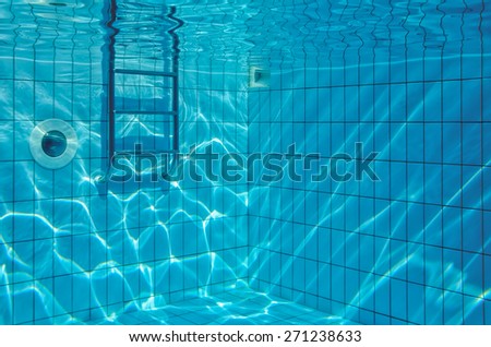 Underwater view of sun reflections in pool