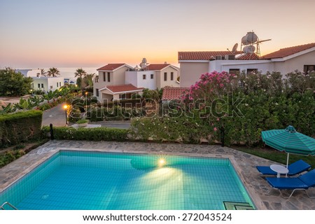 Holiday villas with pool in sunset light