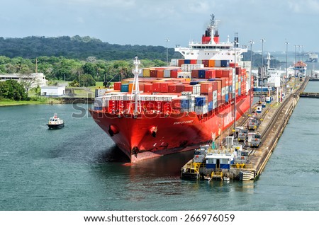 Panama Canal, Panama - February 20, 2015: Ship in Miraflores Locks Panama Canal, electric locomotives pull ships in transit through the locks  the Panama Canal