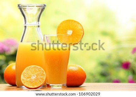 Two glasses of orange juice and fruits