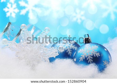 Blue Christmas bauble,snowflake and ribbon in winter setting