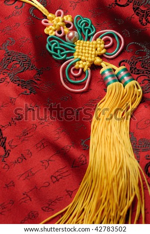 Oriental handicraft,Traditional lucky knot on Jin-Silk background.lucky Chinese knot pray the safety and property for the owner.
