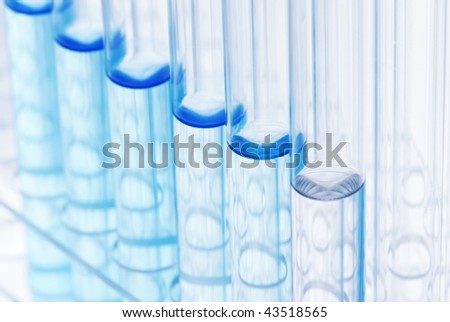 Row of glass tubes with liquid on Test Tube Racks,Closeup.