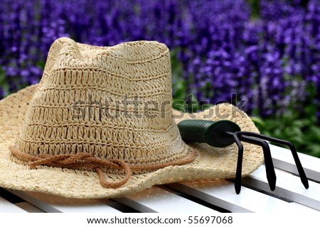 Garden Hats on Straw Hat And Gardening Tools In The Garden Stock Photo 55697068