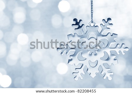 Silver blue snowflake against shimmering background