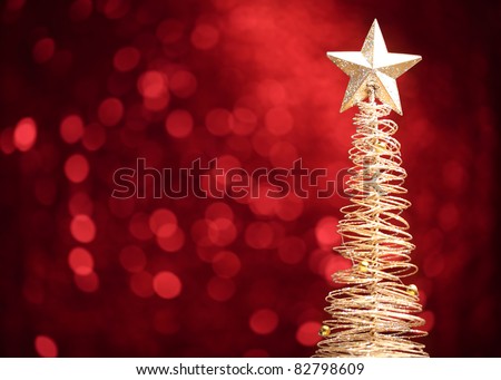 Golden christmas tree on abstract light background.