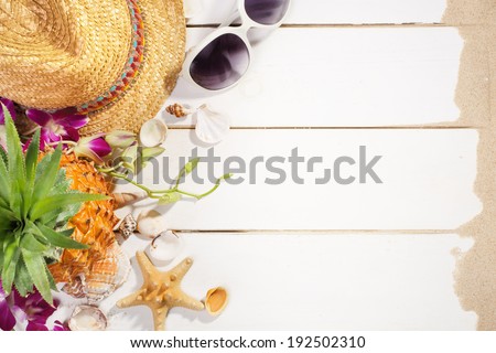 Summer holiday setting with straw hat, pineapple and sunglasses
