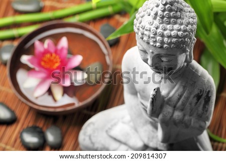 Spa and wellness setting with buddha and flowers,Shallow Dof.