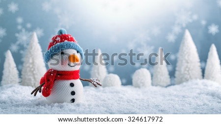 Snowman and Christmas decorations in the snowy day.