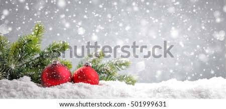 Christmas tree with red balls on snow