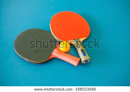table tennis racket and ping pong ball on table