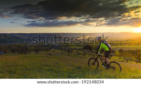 man on mountain bike on sunset