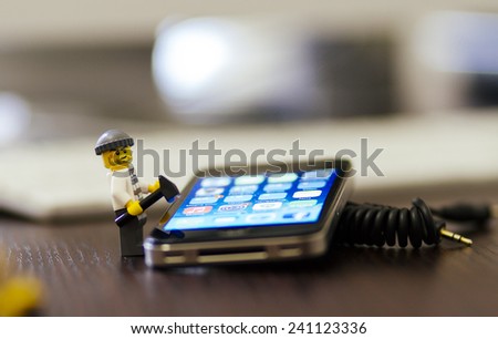 Orvieto, Italy - December 27th 2014: Lego mini figure thief on iPhone. Lego is a popular line of construction toys manufactured by the Lego Group