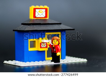 Orvieto, Italy - May 13th 2015: Young woman sends mail in the mailbox. Lego is a popular line of construction toys manufactured by the Lego Group