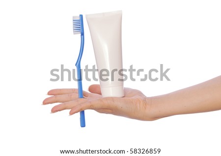 Tooth-paste and brush at in the girl\'s hand