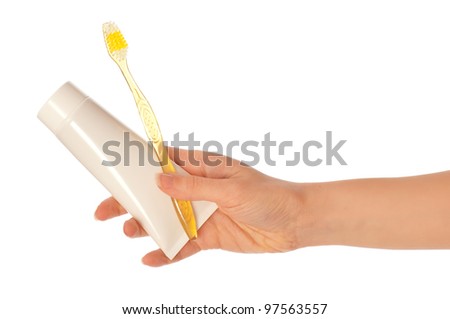 Tooth-paste and brush at in the girl\'s hand