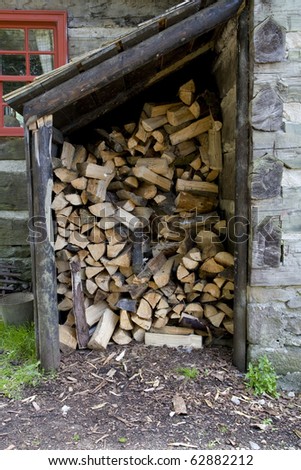 Chopped firewood stored in a covered outdoor shelter