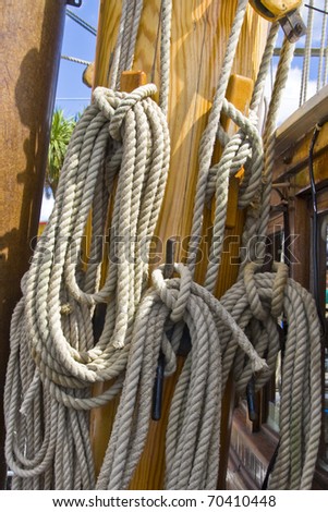 Ship`s ropes coiled on hooks  on board a sailing ship