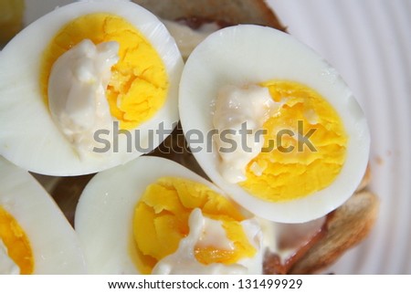 Halved and hard boiled egg yolks with a dab of mayonnaise