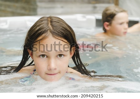 Cute young girl relaxing in a hot tub