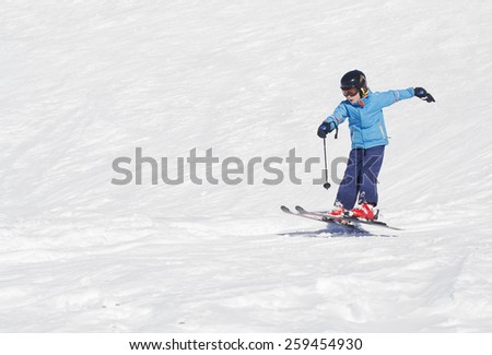 Young boy landing a ski jump