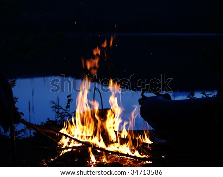 night and fire on lake shore