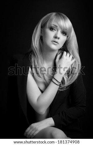 Portrait of a beautiful blonde young girl wearing a jacket black and white