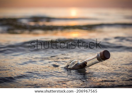 Message in a bottle in the sea sunset