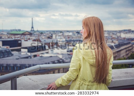 Young woman posing in front of Eiffel Tower in Paris