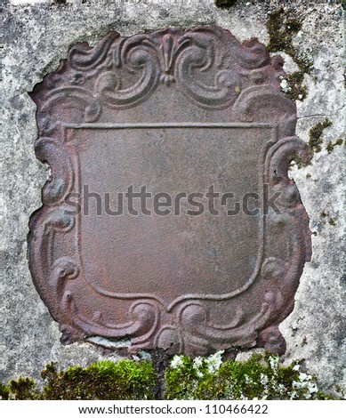 Rusty decorative metal plate in a wall