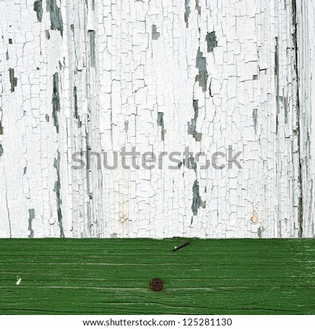 Background of white and green peeling paint on an old wall