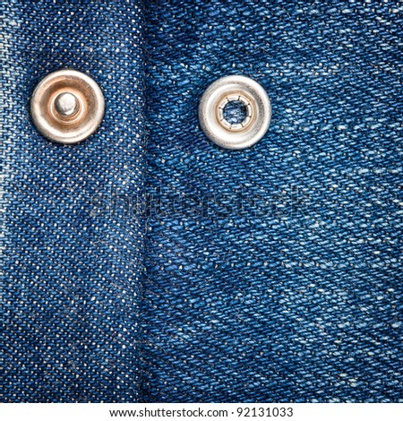 Worn blue denim jeans texture with press button