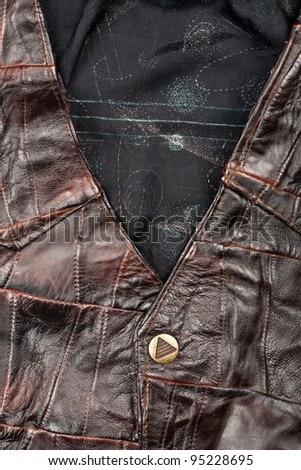 Fragment of brown stitched leather piecies vest