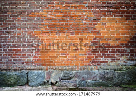 Red brick wall background with stone basement